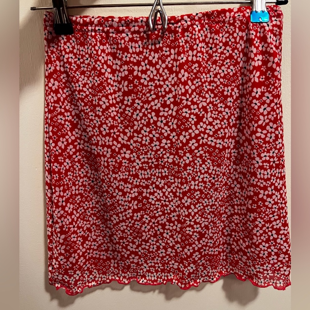 Super cute red skirt with white and black flower pattern. Elastic waist band